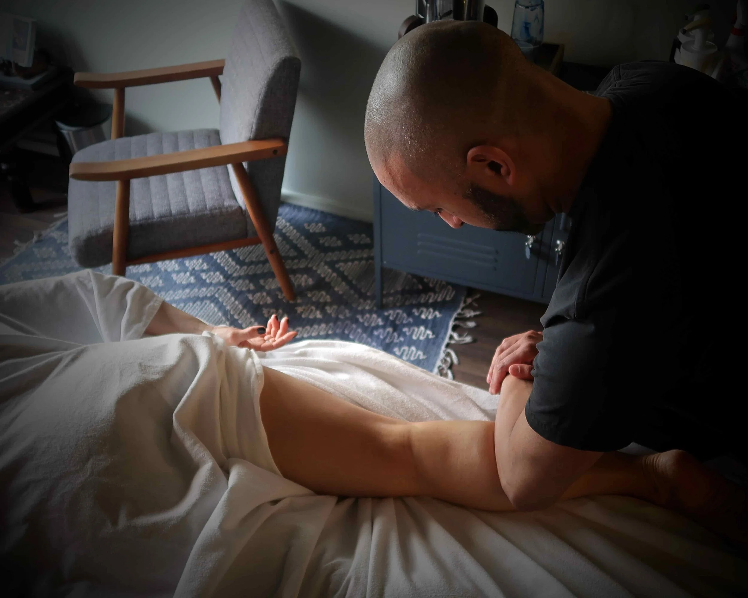 Sports Massage Therapist Steve Berry providing deep tissue massage treatment on the calf muscle of a runner's leg.