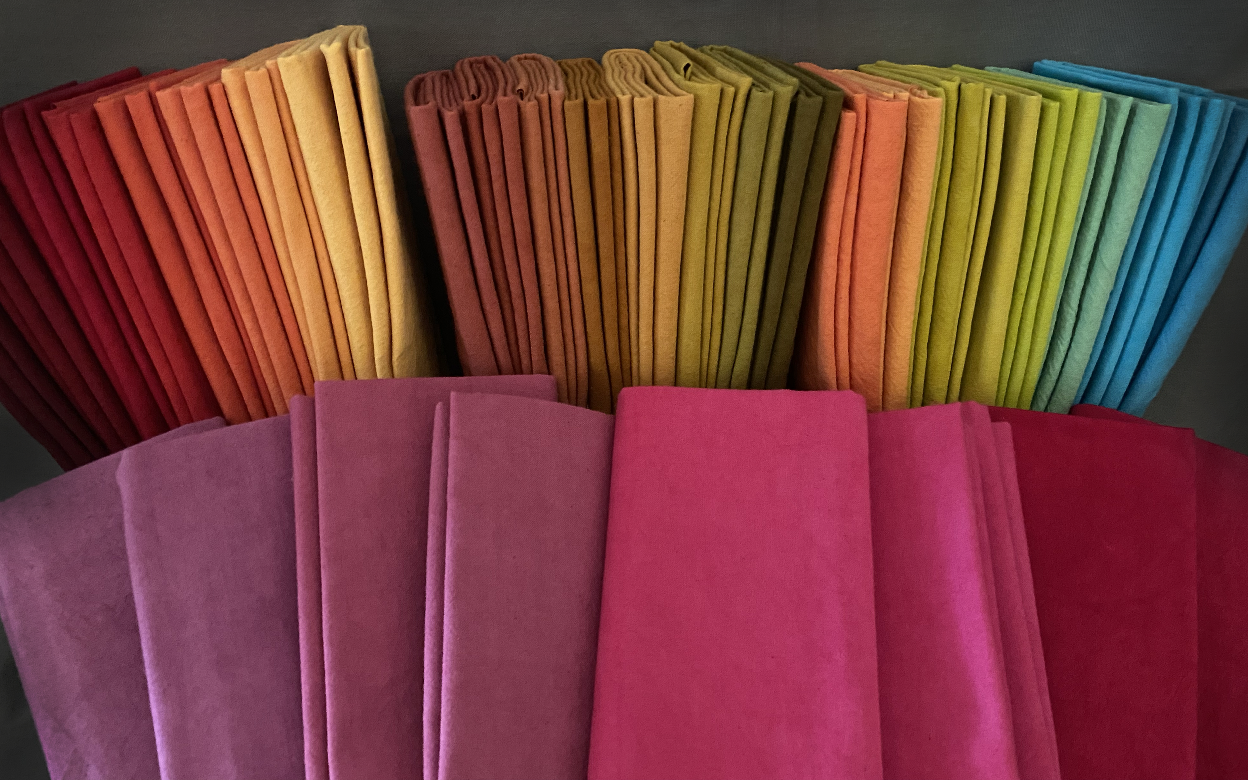 An array of Cherrywood Fabrics spread out to show a wide range of colors