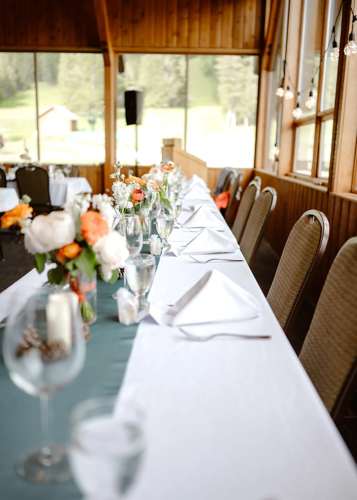 A detailed look at the reception dinner table layout during a romantic mountain wedding with elegant decor