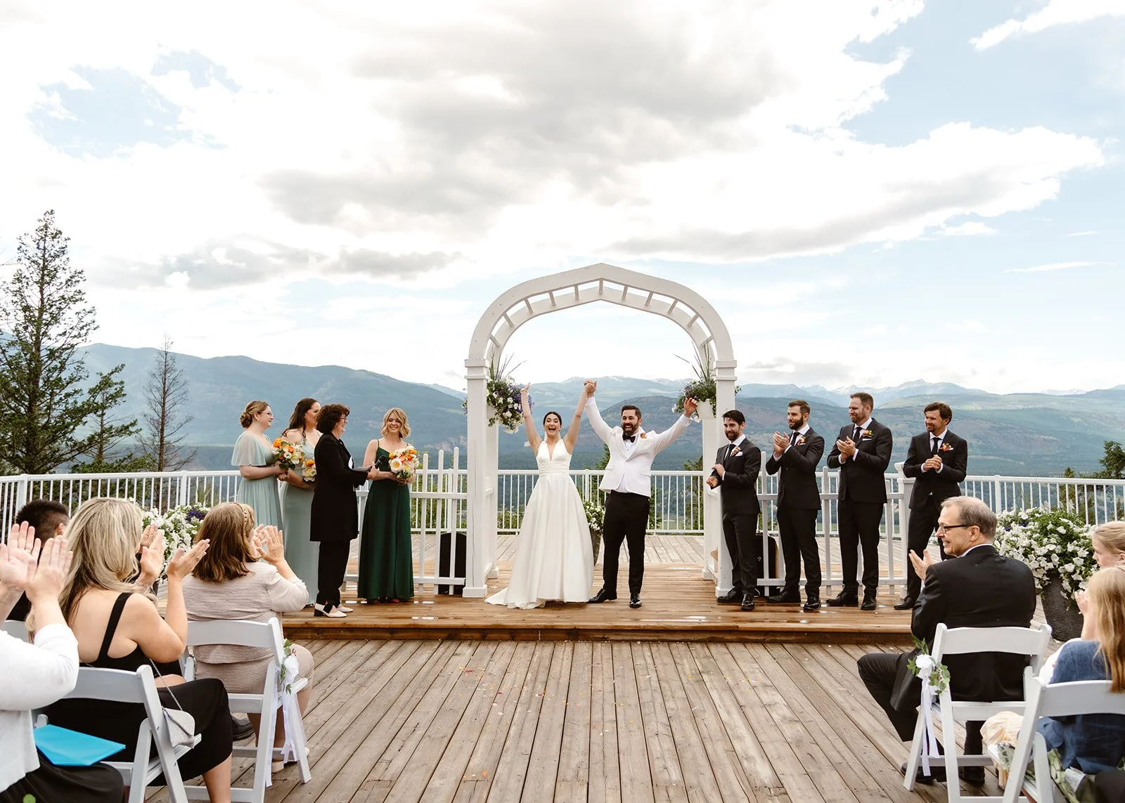 The couple celebrates their union at the altar during their romantic mountain wedding ceremony, capturing a joyful and unforgettable moment