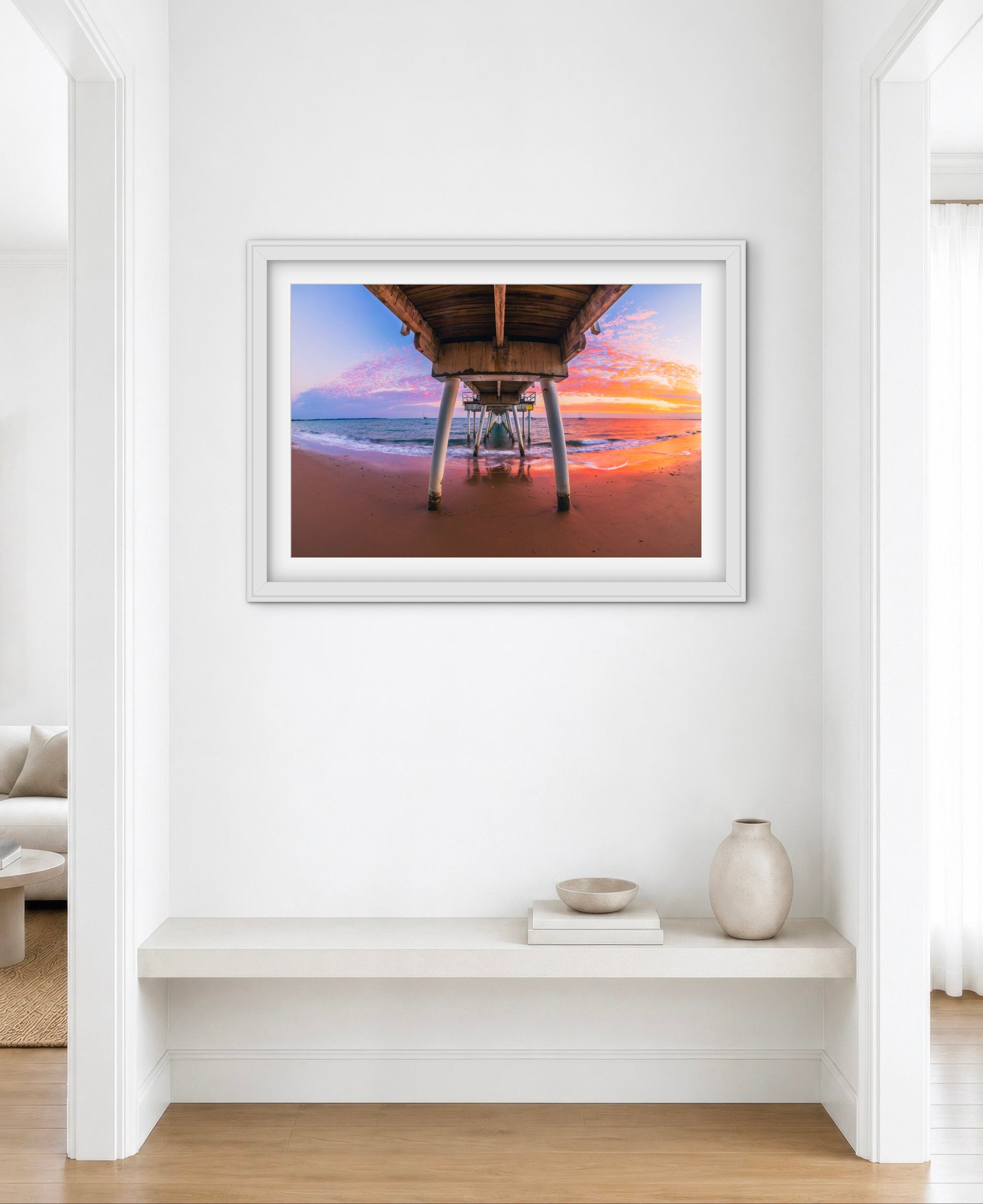 Room mock-up showing Scarness Jetty at Sunset as framed wall art.
