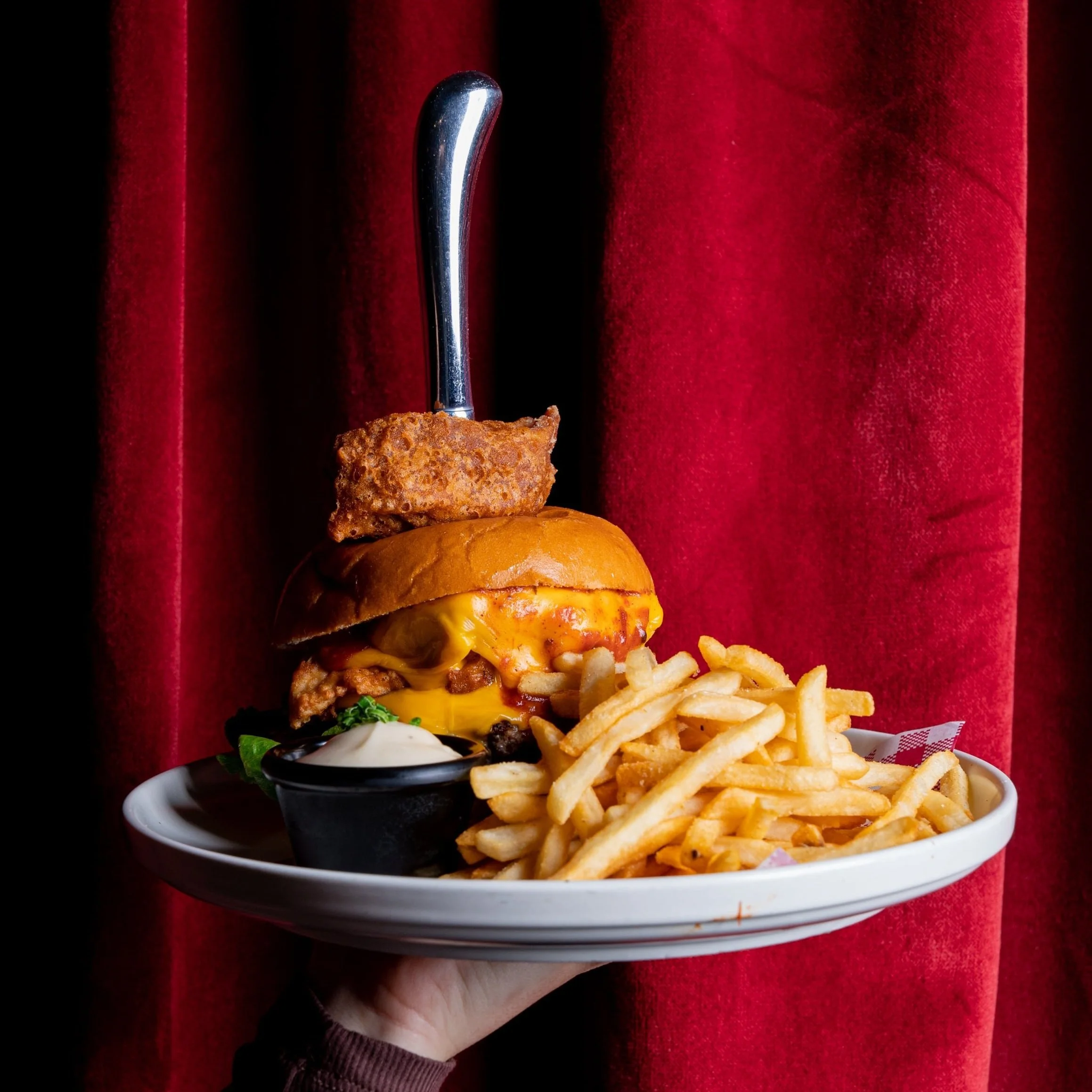 Burger with cheese, pickles and fries served for lunch Brisbane CBD at Miss Demeanour