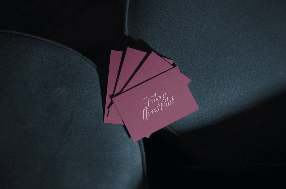 Magenta business cards fanned out on velvet