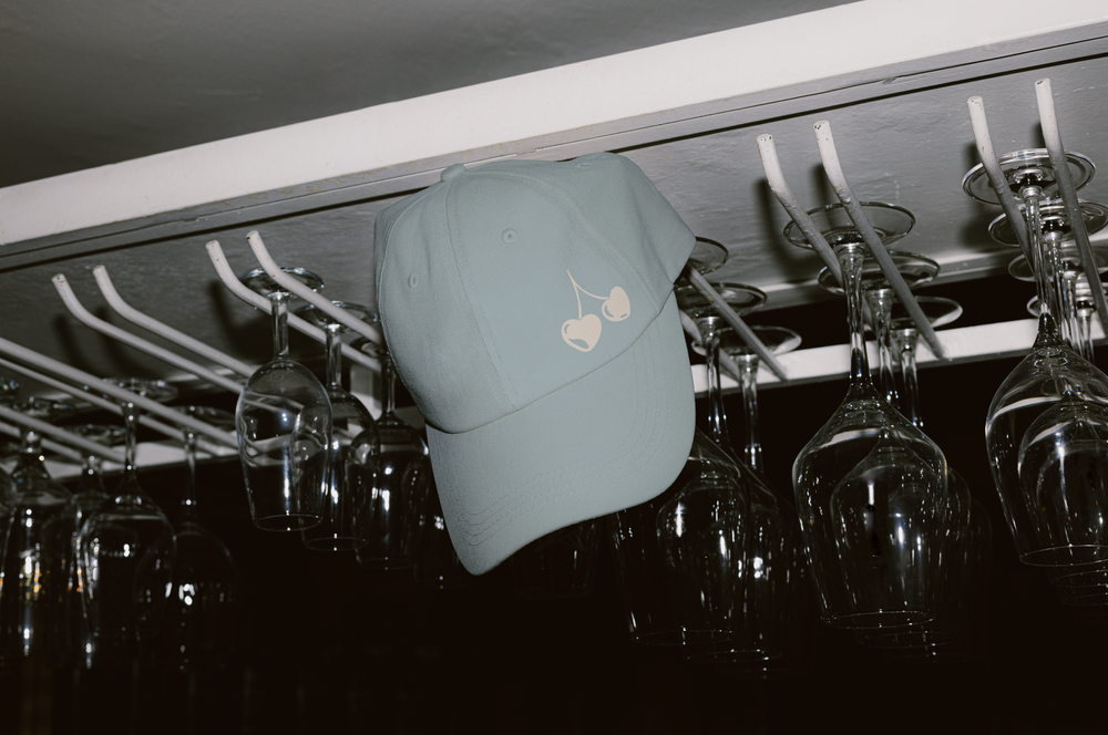 The cherries on a powder blue cap