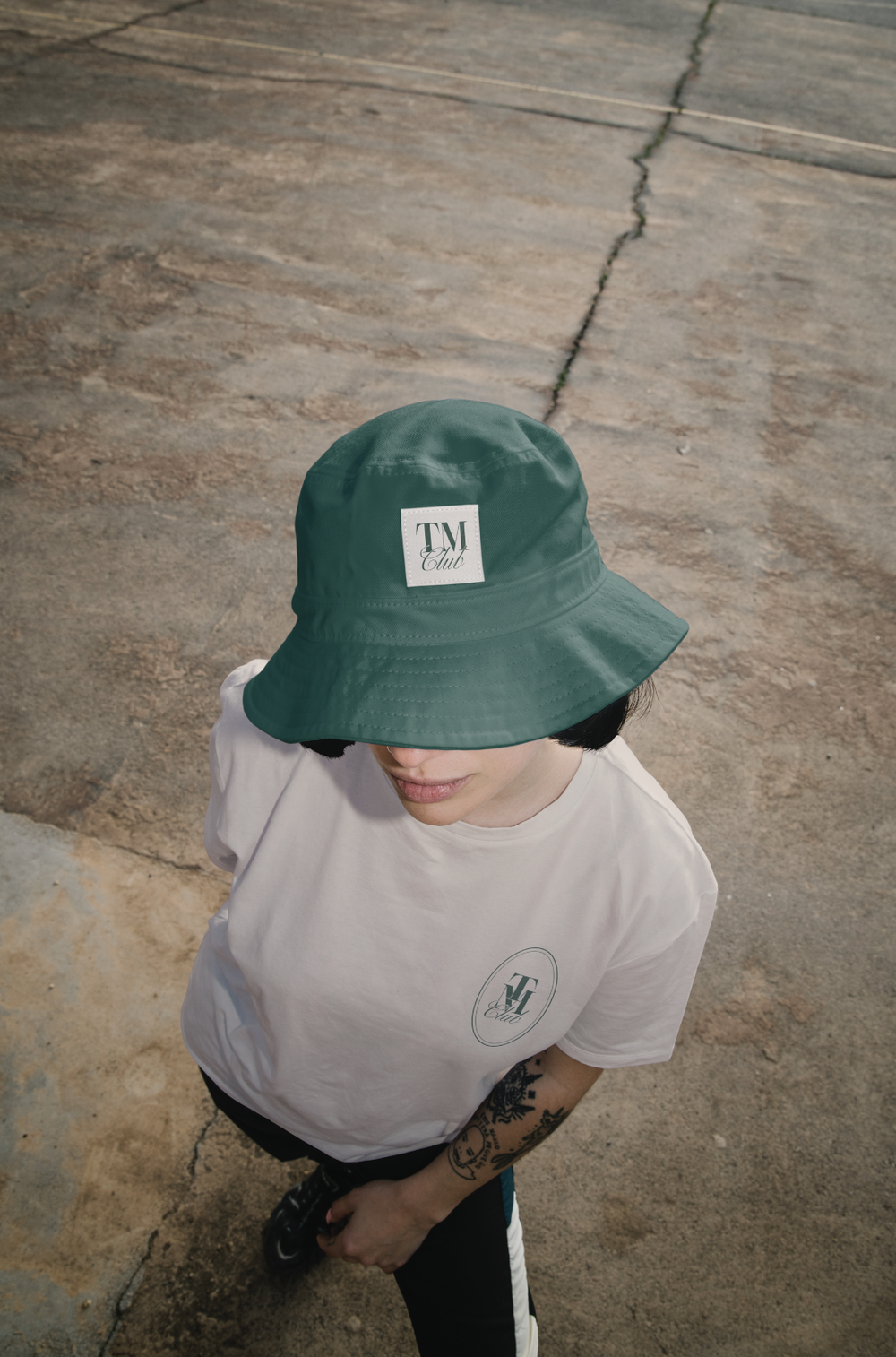 A green bucket hat with the TM patch