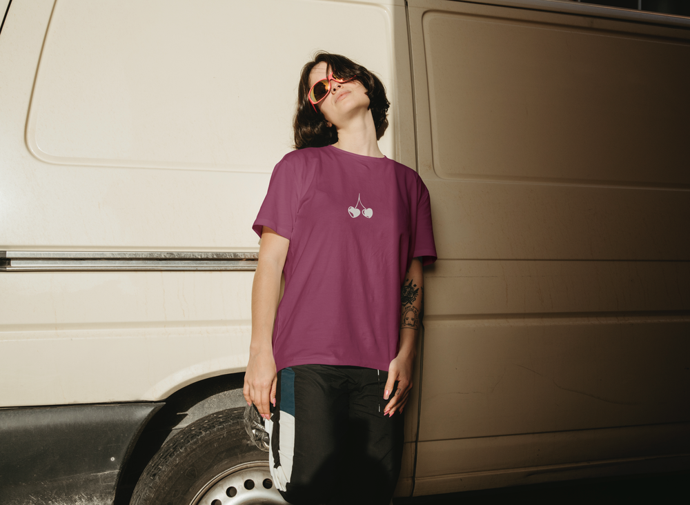 The cherries on a magenta tee