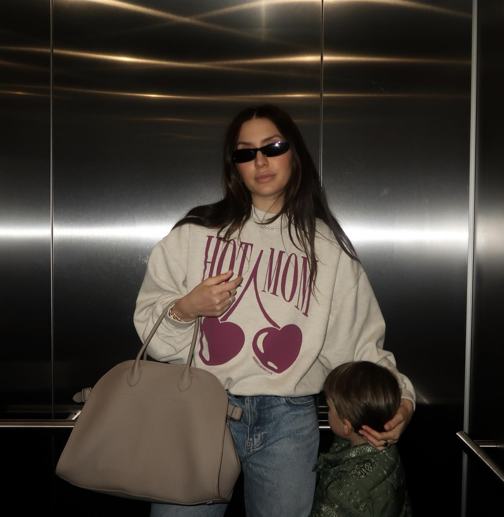 Madison in the HOT MOM crewneck in an elevator, with her son