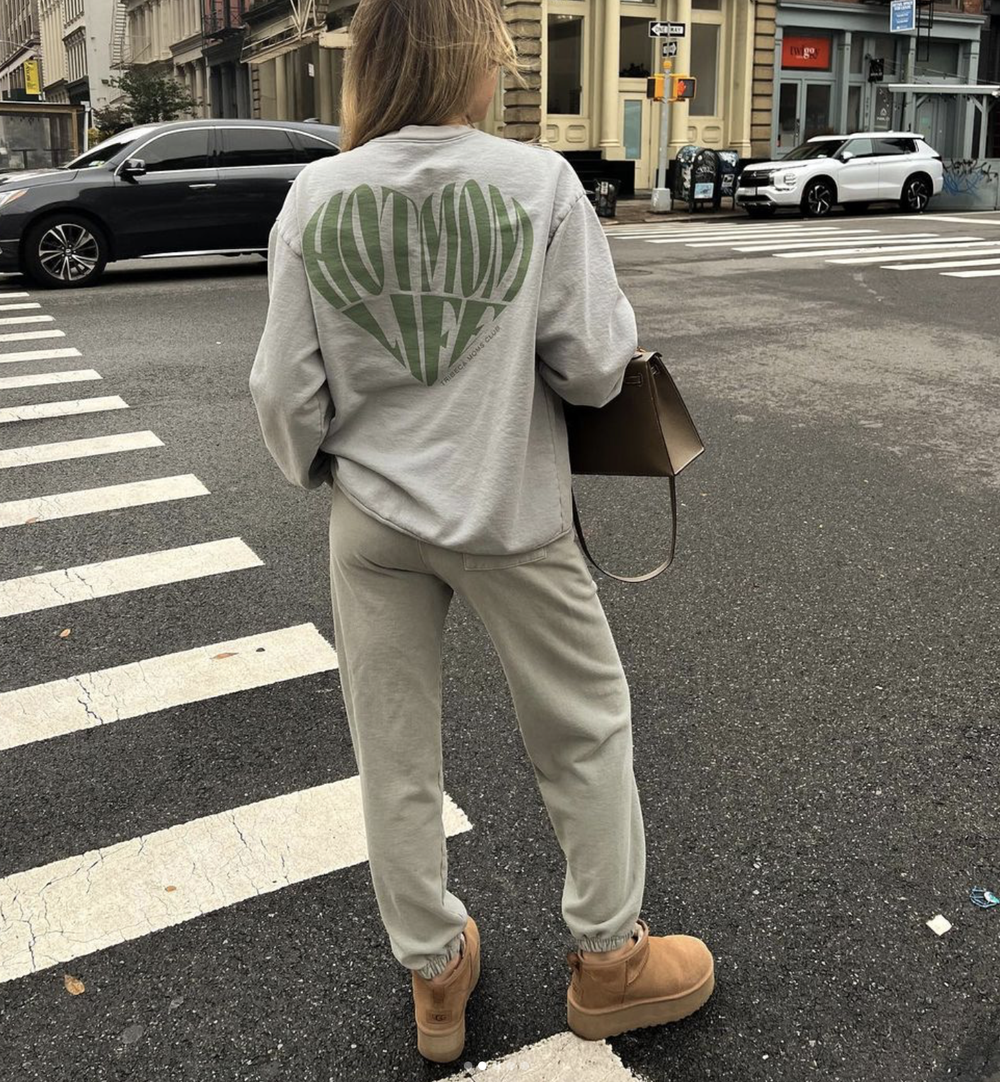 The green heart graphic on the back of a gray sweatsuit