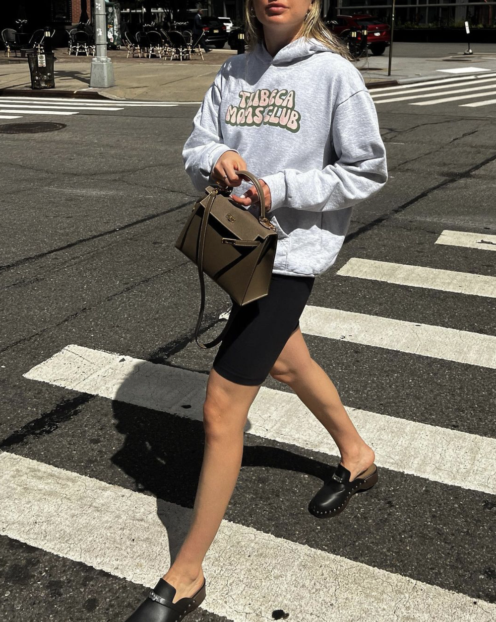 Madison in the bubbly logo hoodie on a crosswalk