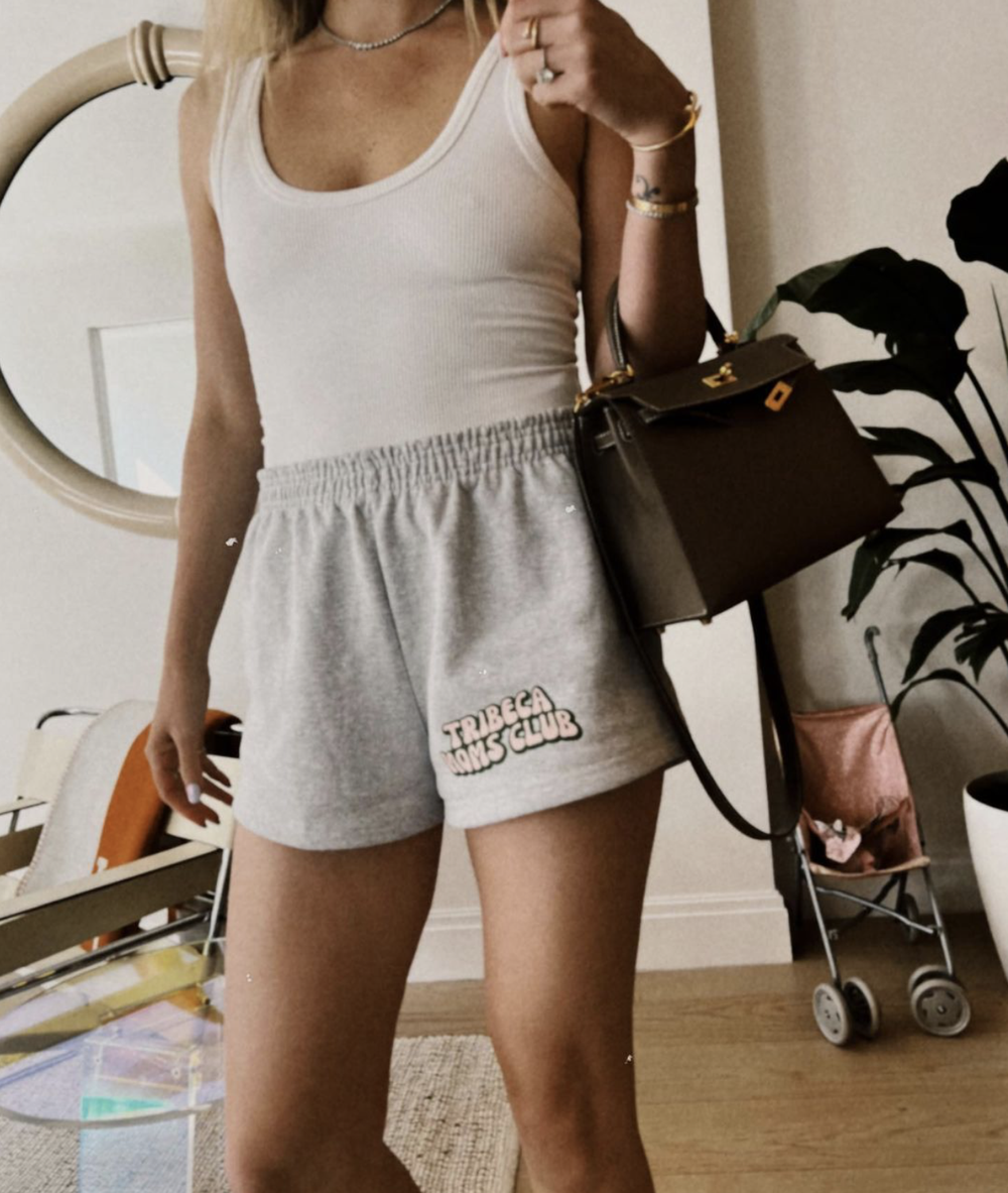 The logo on gray sweat shorts