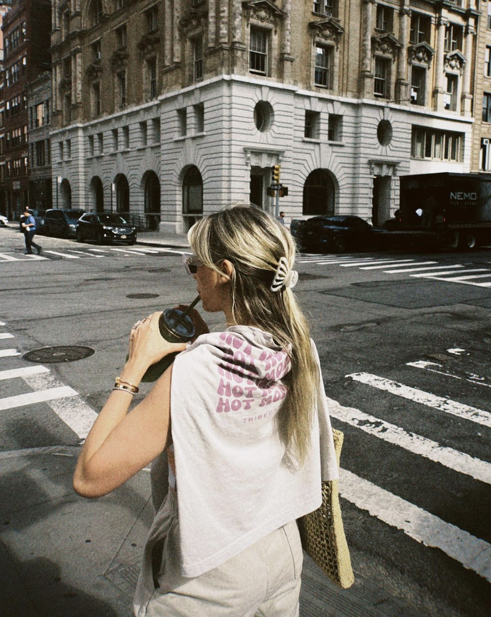 A white cropped tee with a pink hot mom print