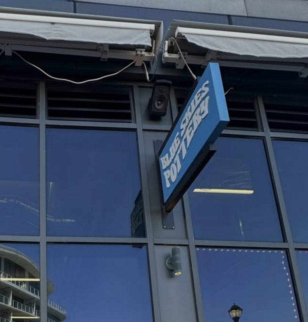 The hanging Blue Skies Pottery sign in Long Branch