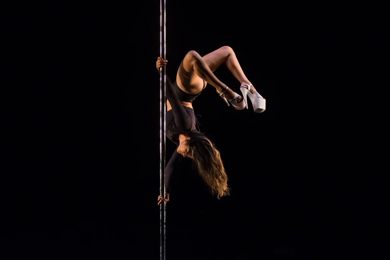 Camille upside down on the pole in clear heels