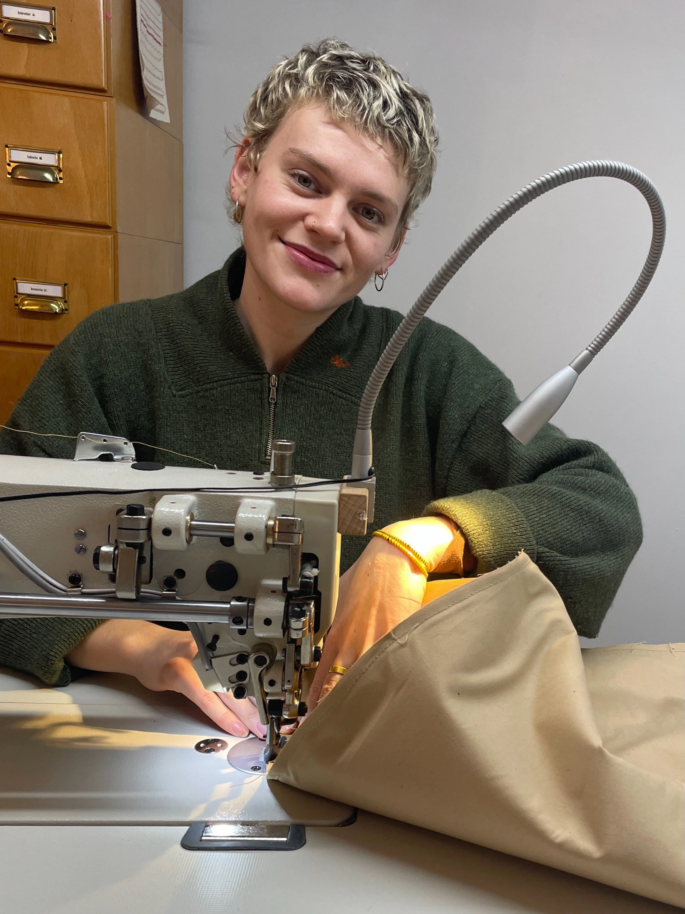 Nora is sewing a punching bag in the studio