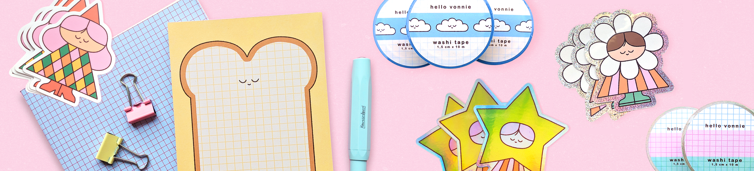 Assorted cute stationery and stickers on pink background, including character illustrations and writing supplies.