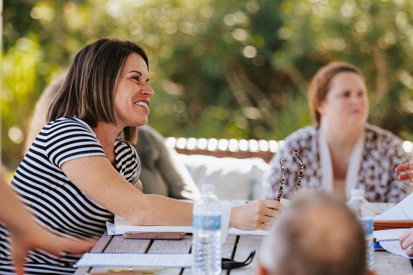 Female PRIDE Philanthropy client at table, discussing an educational topic about fundraising