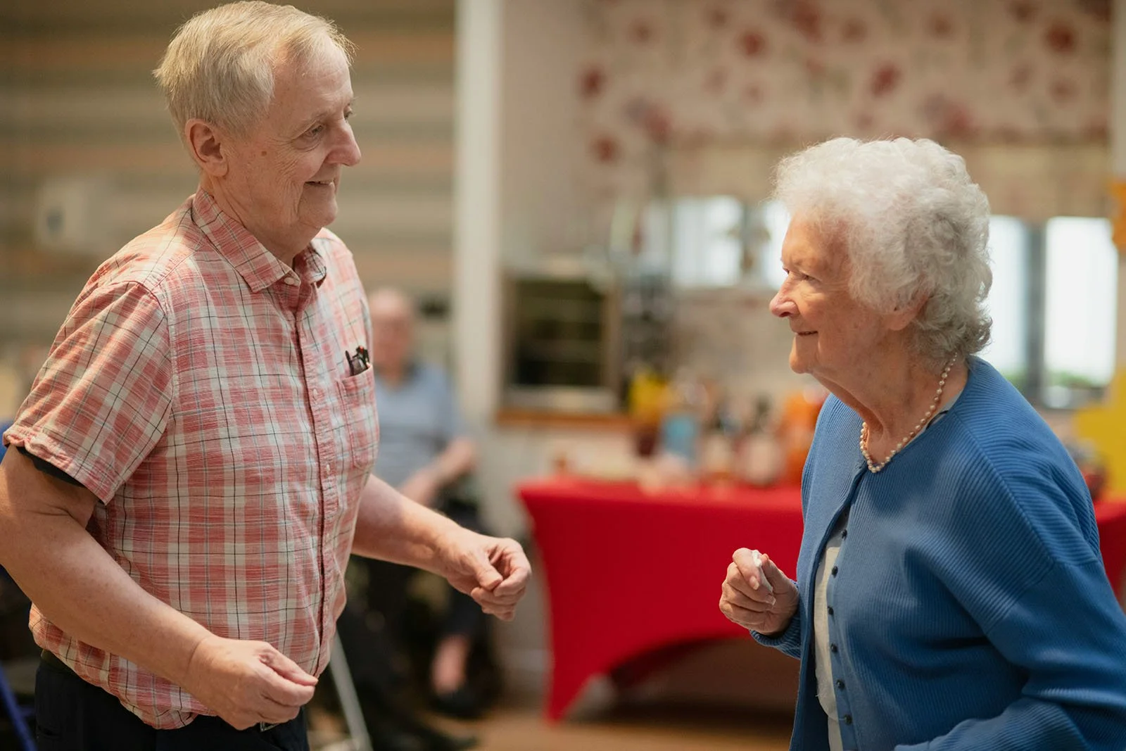 Seniors dancing and smiling at a retirement community