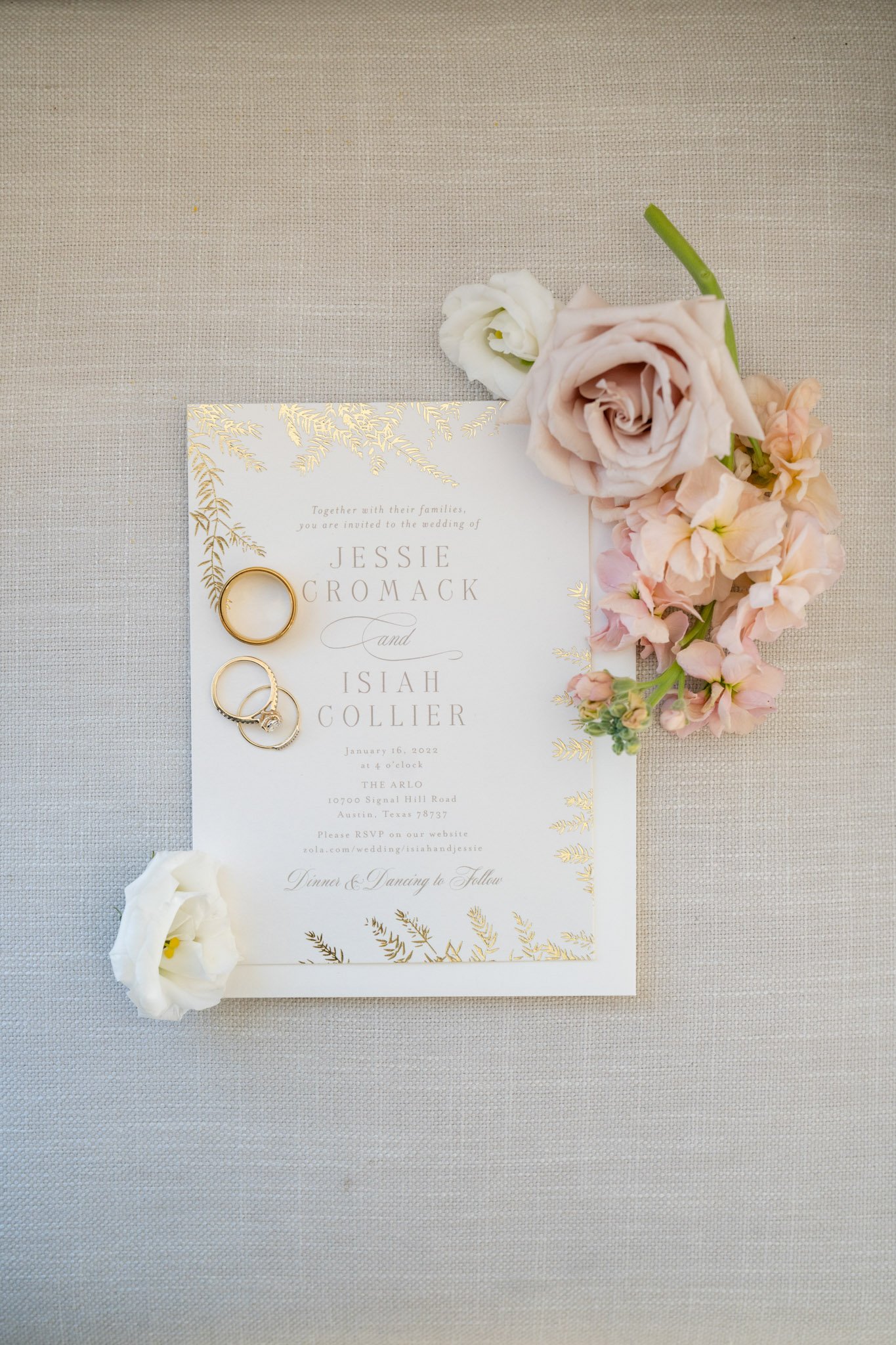 Wedding rings and wedding invitation with pink and white flowers in Austin Texas The Amber Studio