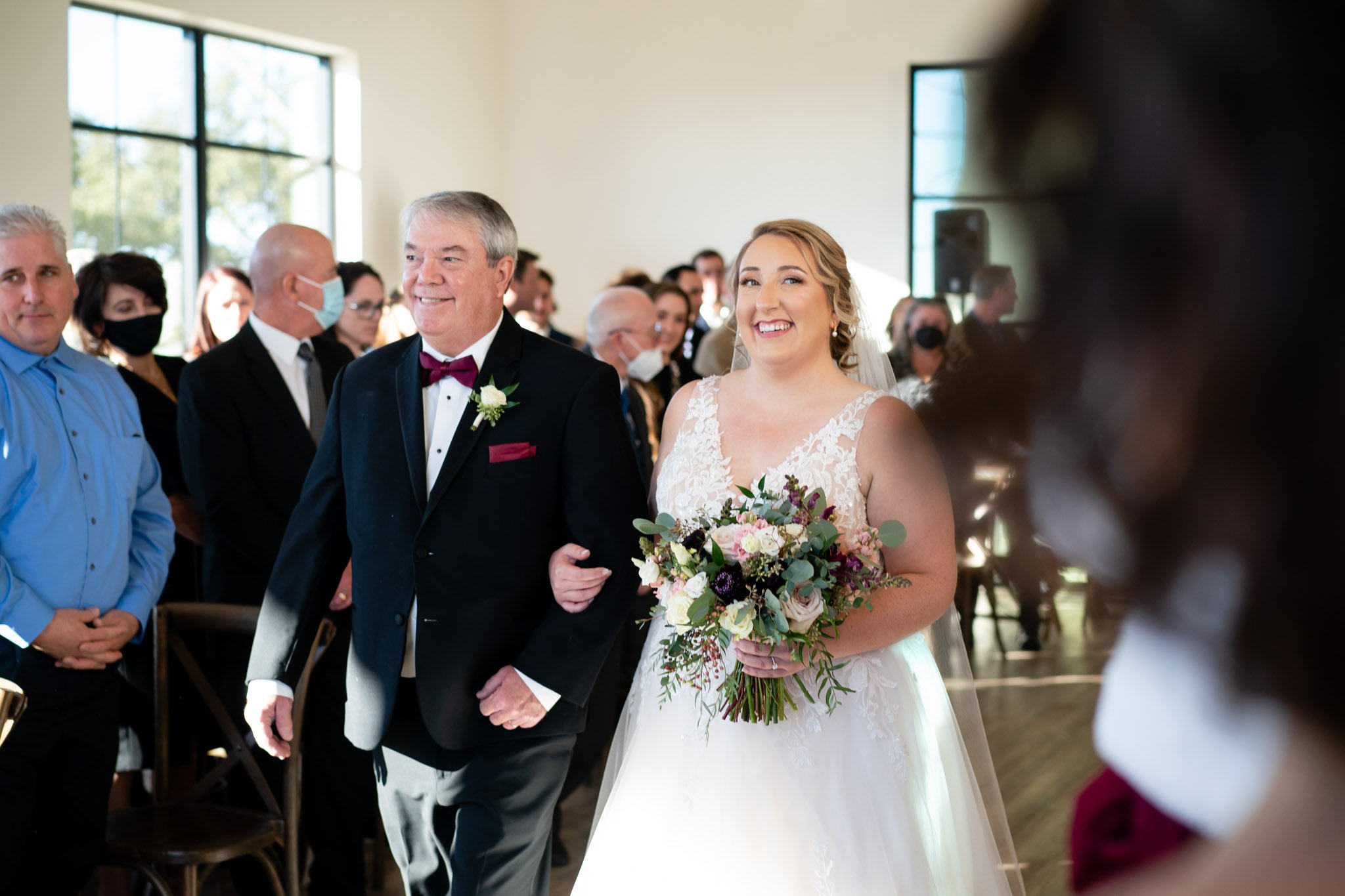 Smiling Bride escorted down the aisle by her father at The Arlo in Austin TX The Amber Studio