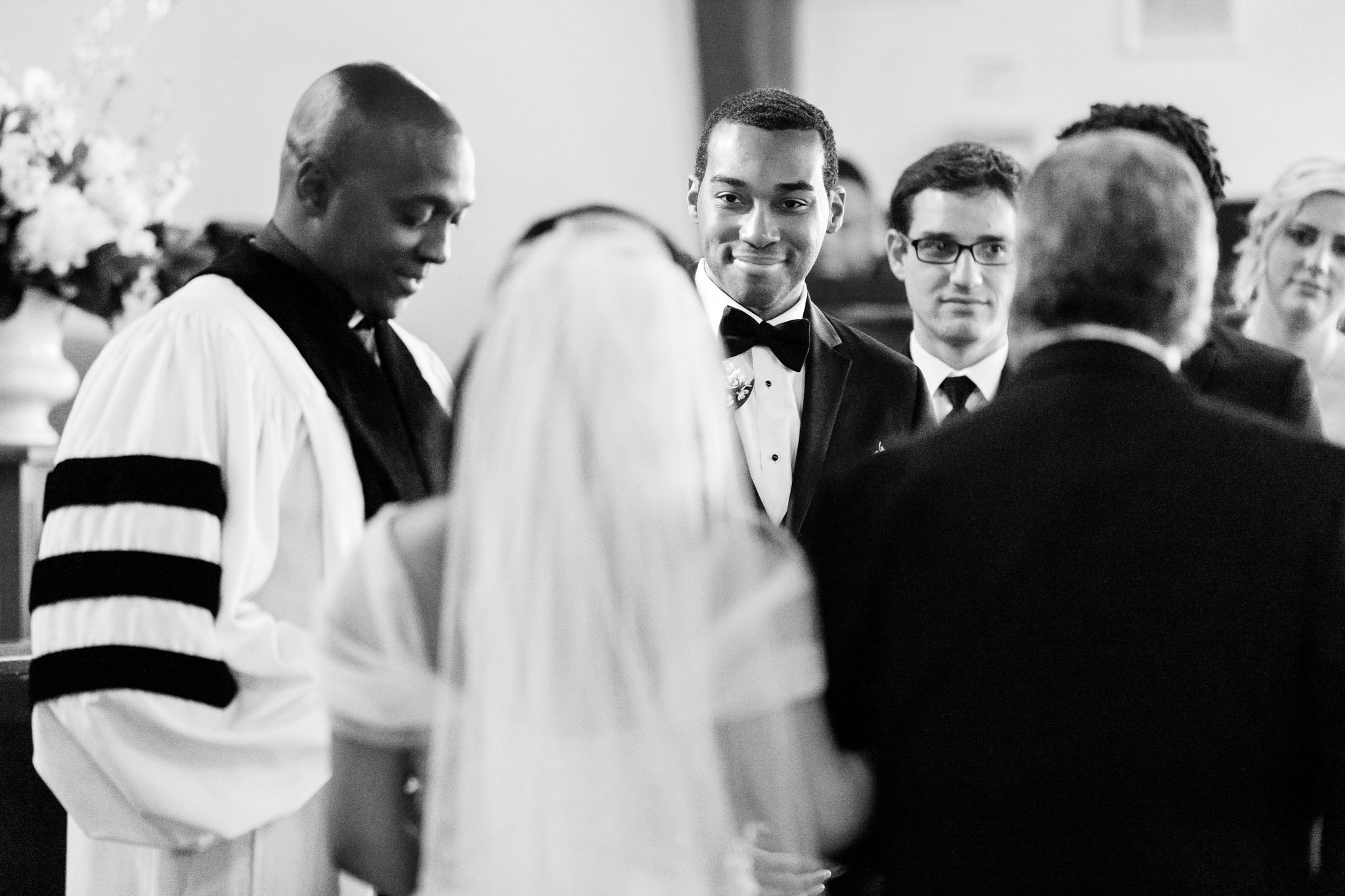 A groom watching the bride walk down the aisle at a church wedding in DFW Texas The Amber Studio
