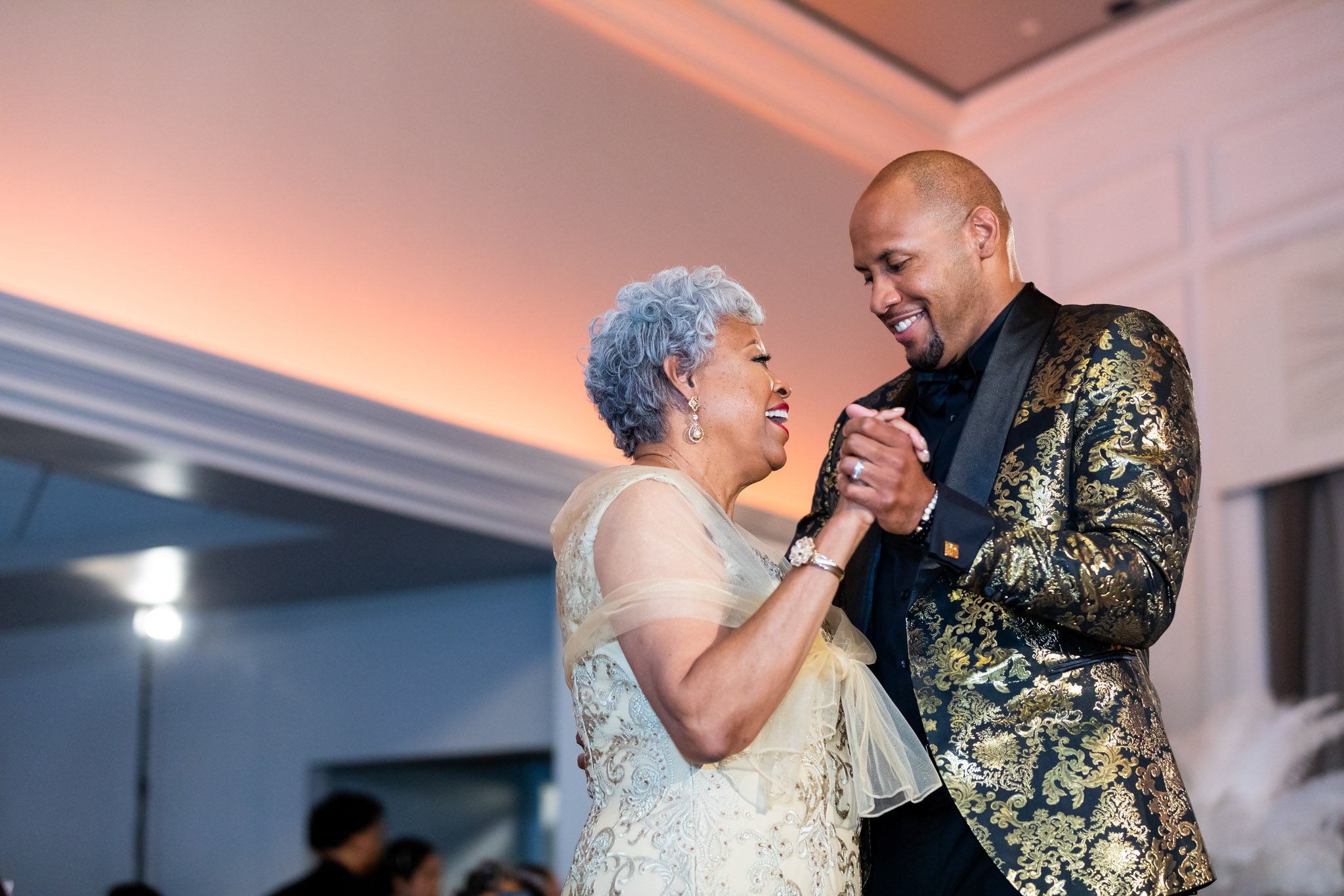 A groom dancing with his mother at the wedding reception in Dallas Fort Worth Texas the Amber Studio