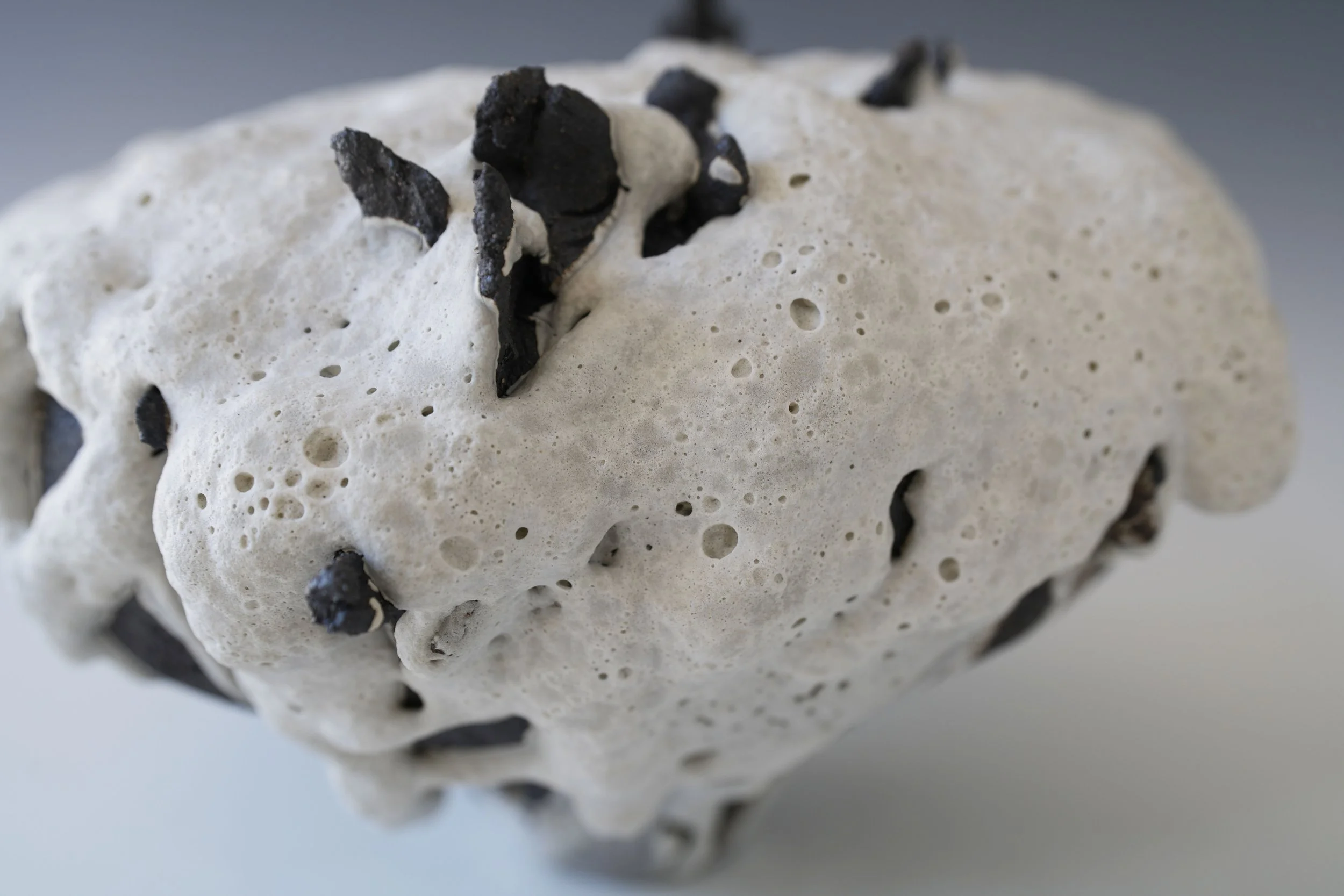 handmade porcelain vase with cratered surface texture