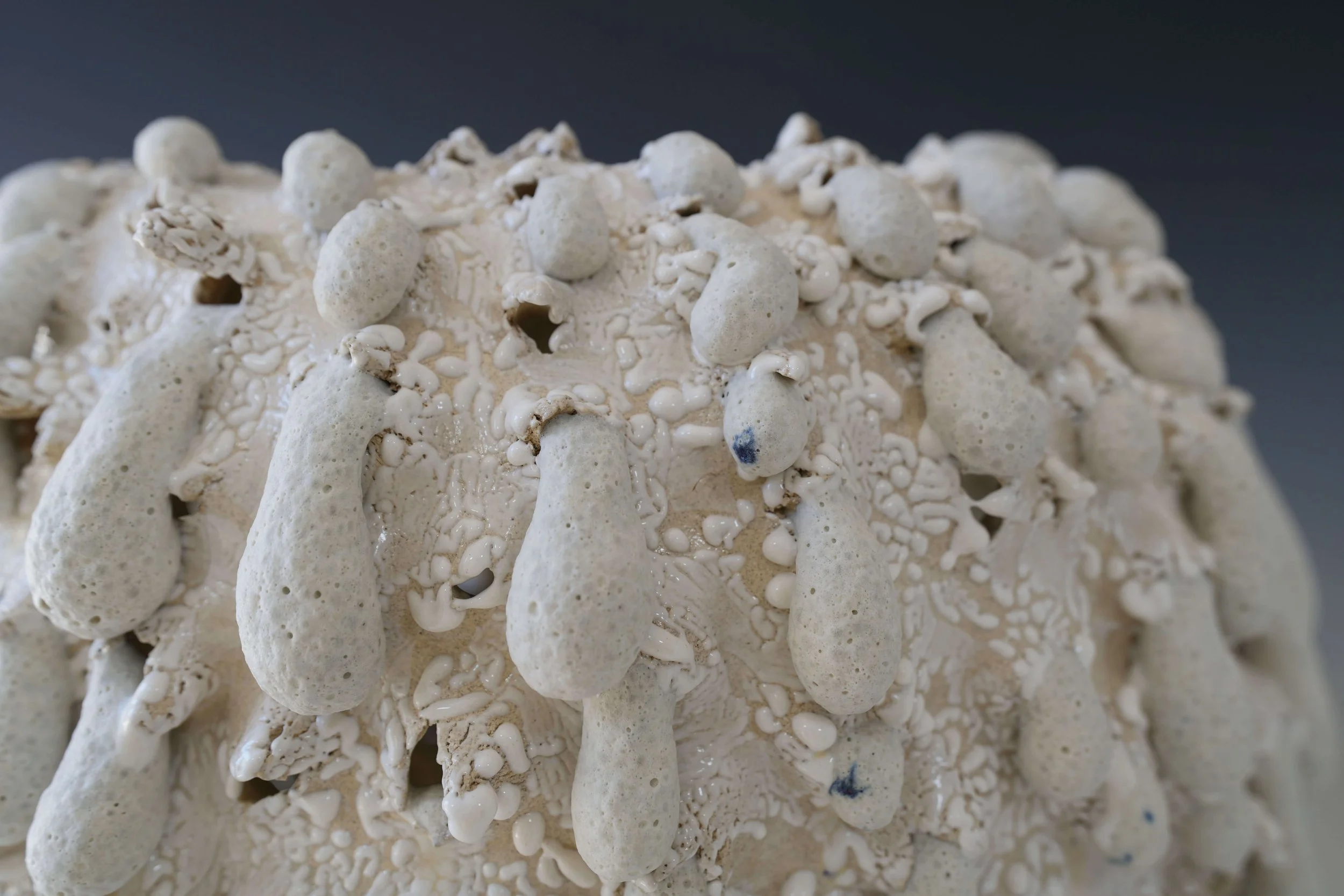 handmade ceramic vase with cratered surface and organic glaze texture