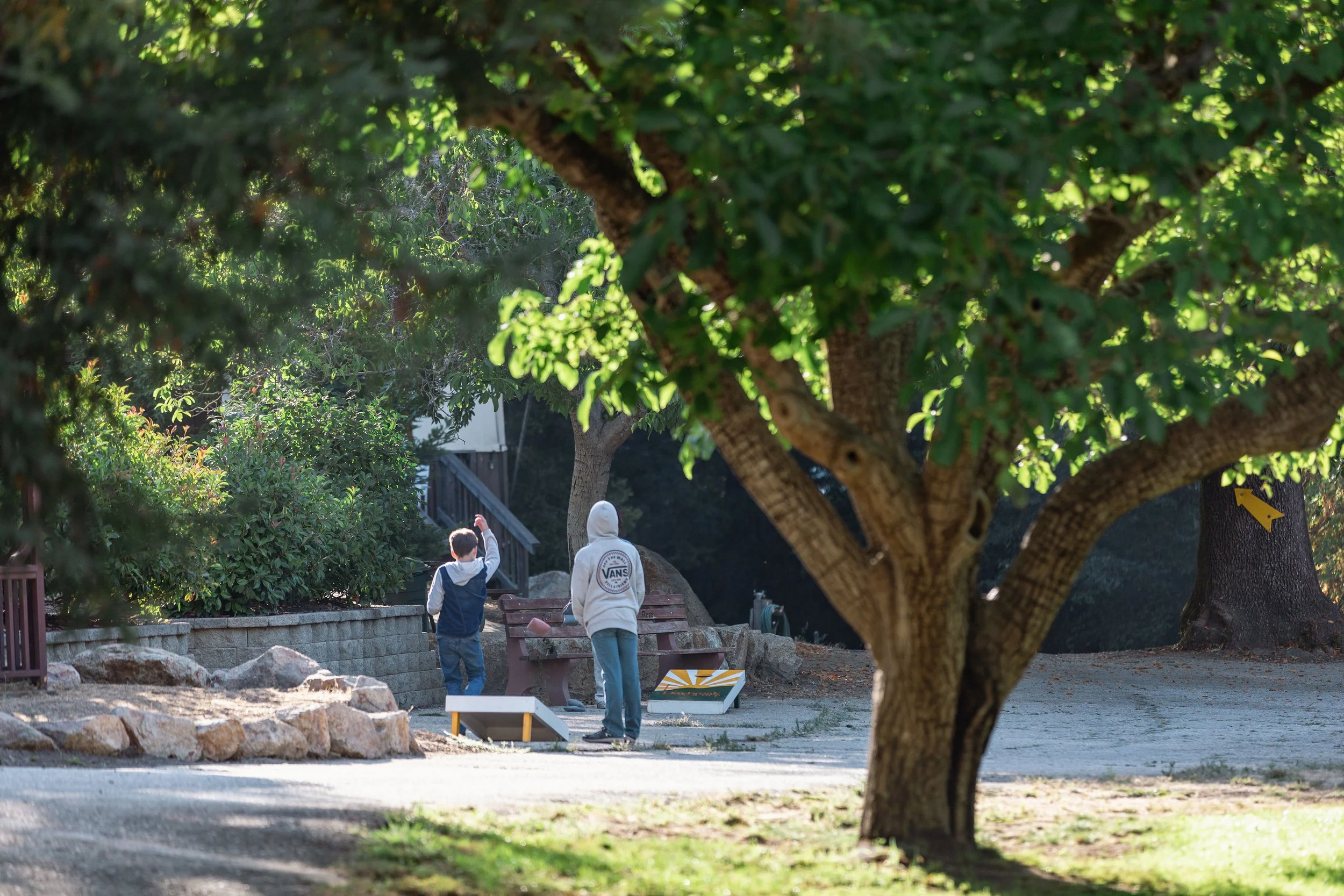 Two people playing corn hole at Daybreak Camp.