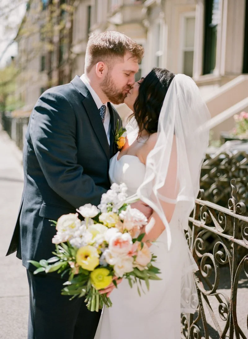 Soft, romantic couple kissing during a spring wedding in New Jersey with natural light and blooms