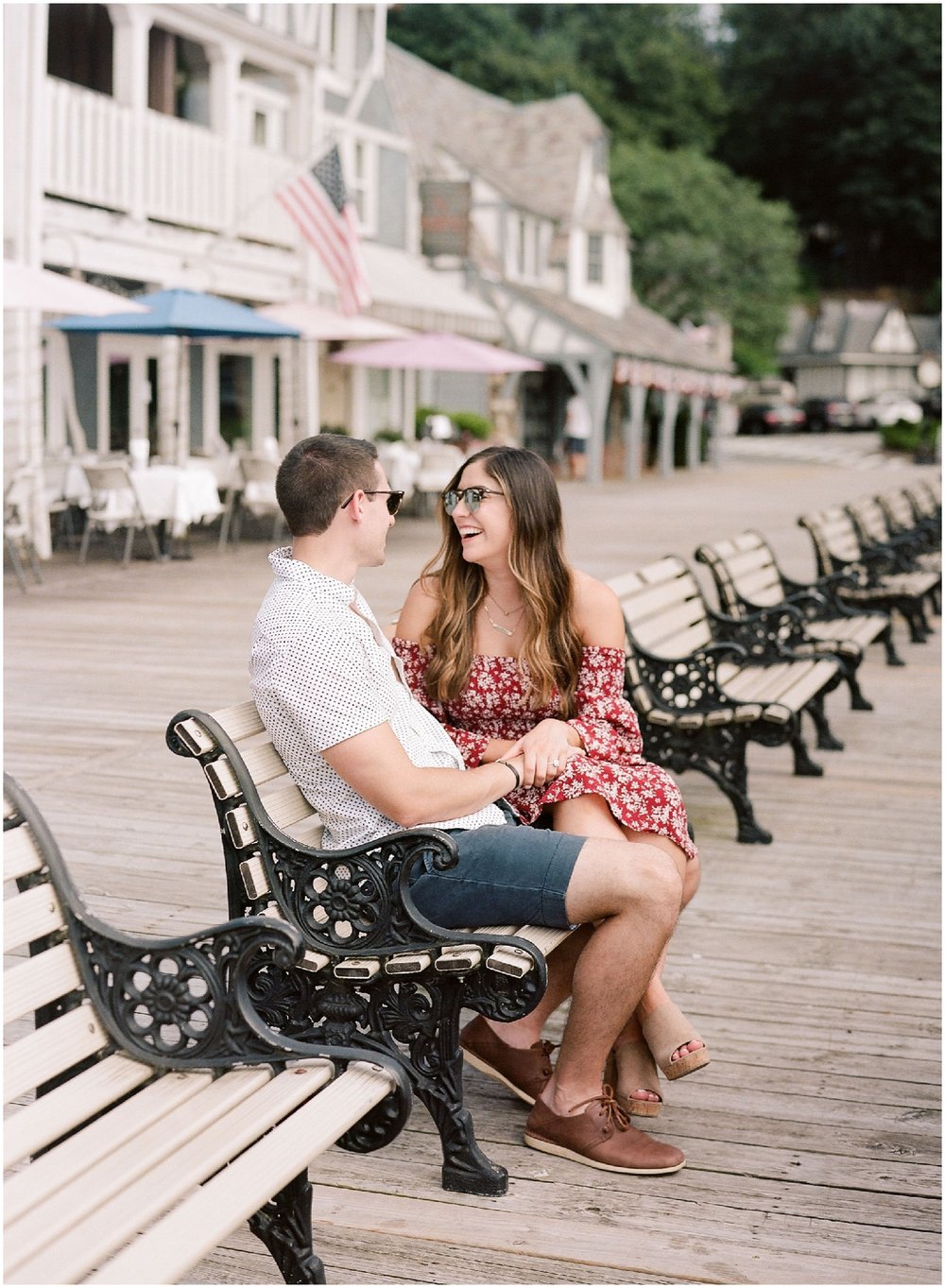 secret proposal, northern new jersey, newly engaged couple smiling and laughing, having fun on the boardwalk near the lake