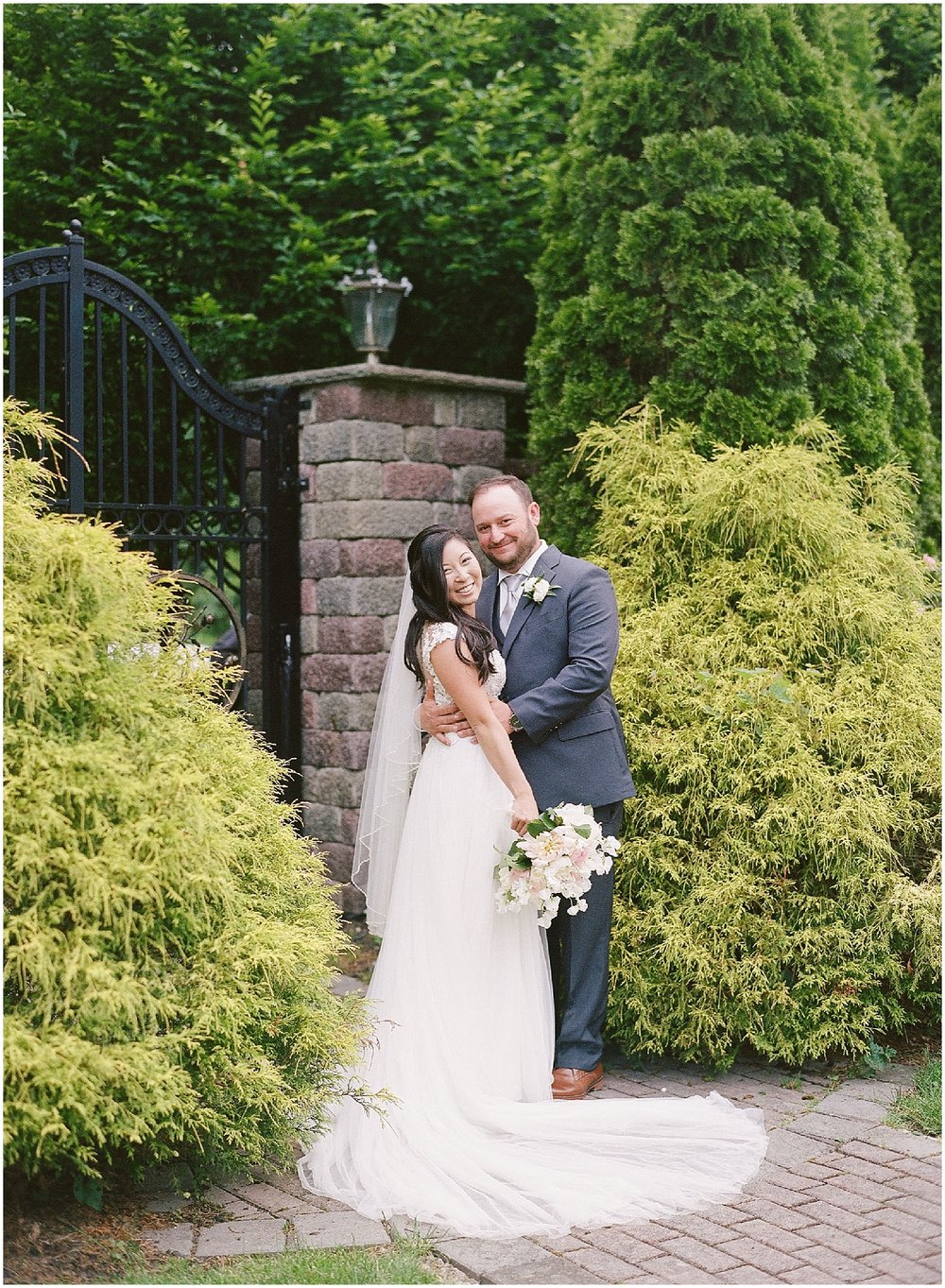 new jersey outdoor wedding, Monmouth University Wilson Hall, natural light photographer, film photographer, bride and groom looking at camera