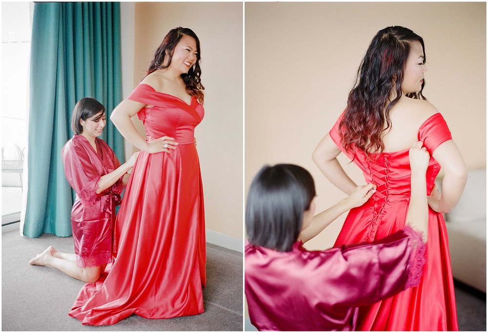 bride getting ready, wearing a red wedding dress in an bride and bridesmaids getting ready at an intimate wedding in hoboken new jersey at the W Hotel