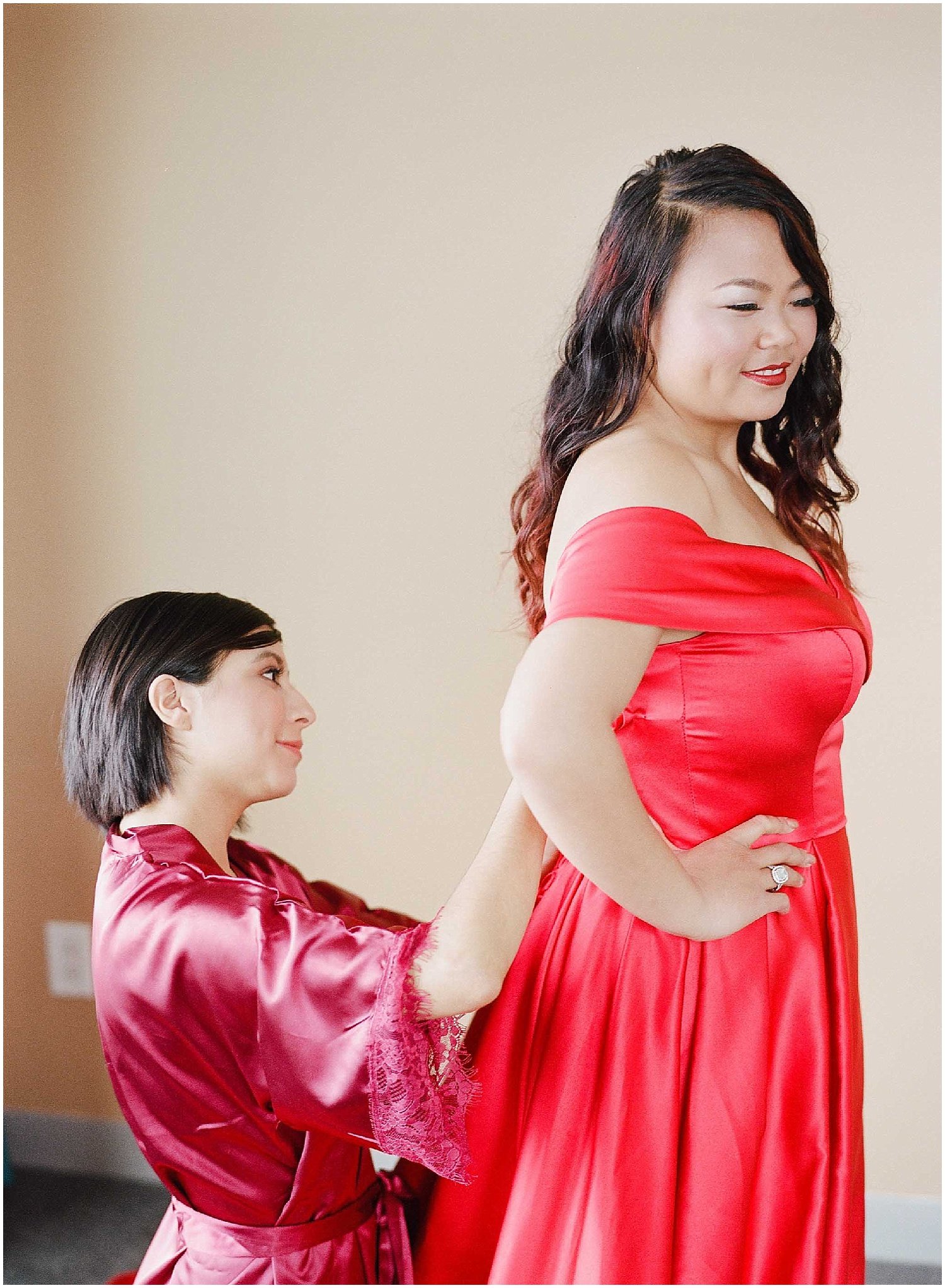 bride getting ready, wearing a red wedding dress in an bride and bridesmaids getting ready at an intimate wedding in hoboken new jersey at the W Hotel