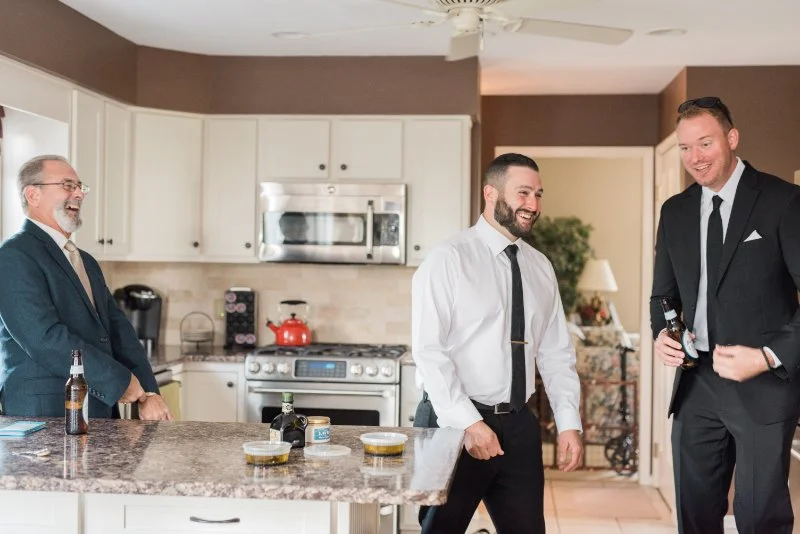  candid photo of groom and his groomsman and father during his getting ready wedding photography  