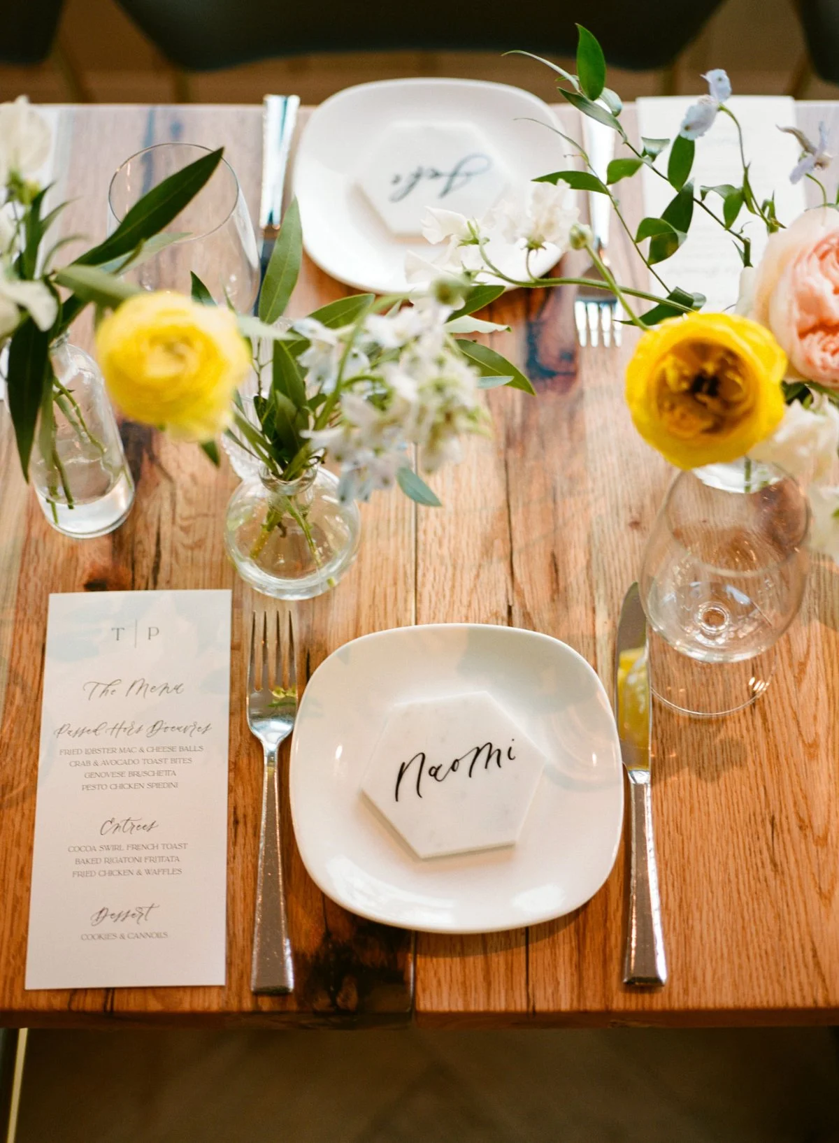  A thoughtful place setting with custom name tile and delicate florals—personal touches that elevate a  luxurious small intimate wedding . 