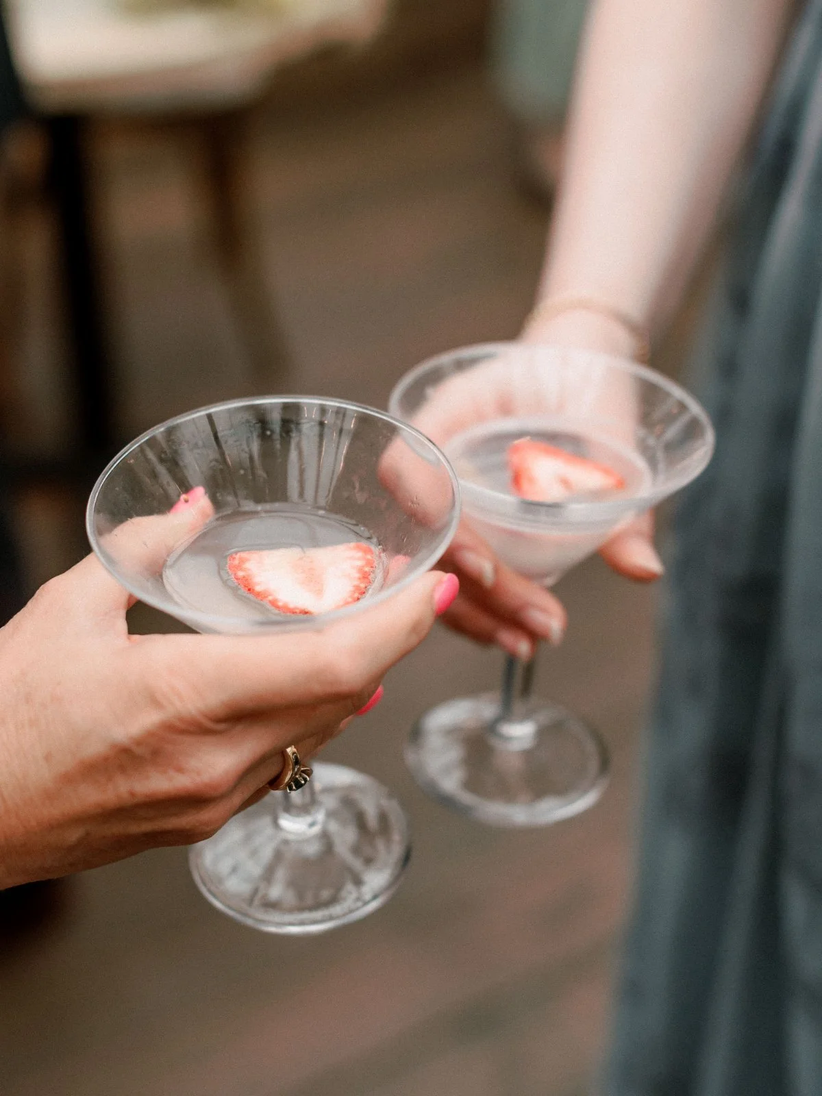  Guests toast with strawberry-garnished cocktails—refreshing and elegant touches perfect for intimate celebrations.   