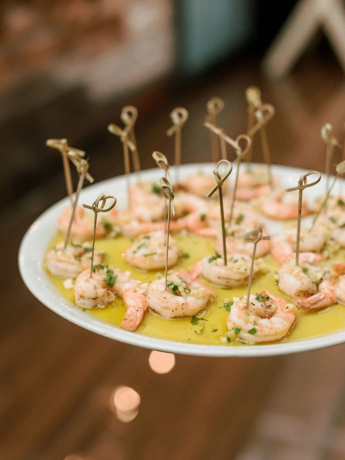  A platter of shrimp in herb butter sauce, ready to serve—elevated bites made for mingling at your micro wedding.   