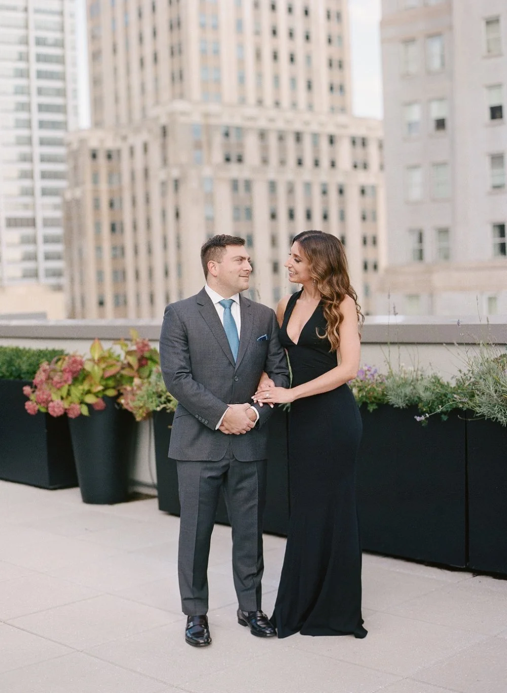  Couple in elegant rooftop attire showing what to wear for engagement photos in a timeless city setting 