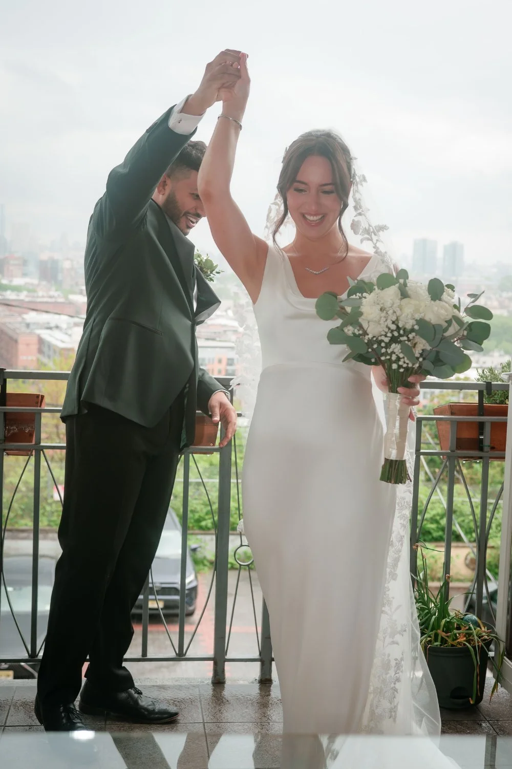  Bride and groom sharing a joyful spin during a wedding first look ideas moment outdoors. 