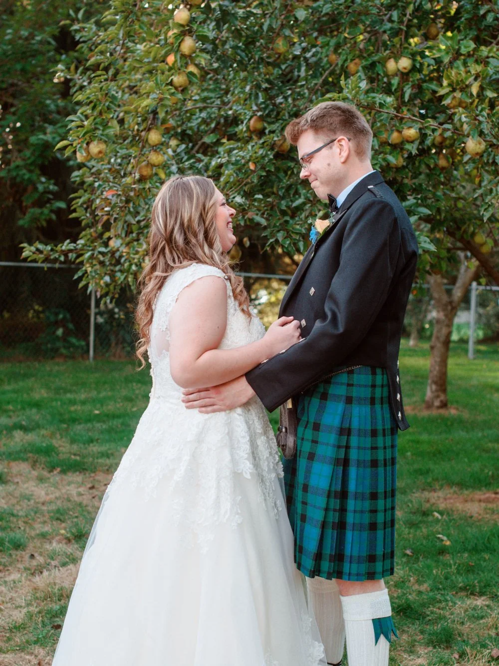  Couple embracing after an emotional wedding first look ideas reveal in a garden setting. 