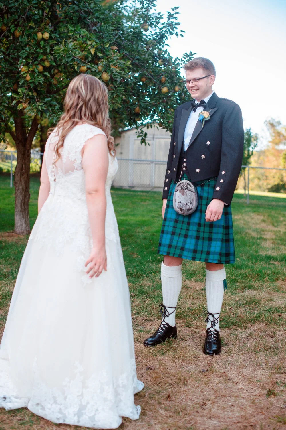  Bride and groom seeing each other for the first time during a wedding first look ideas moment. 