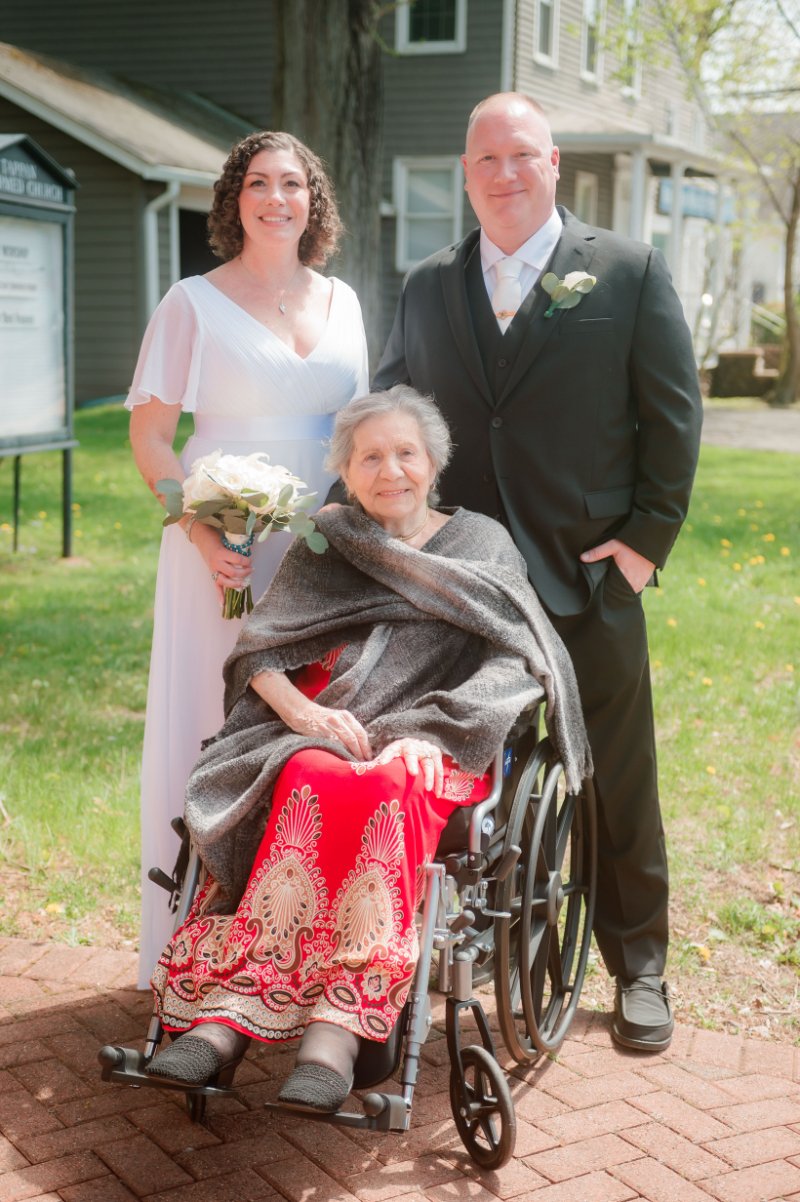 Wedding photography checklist family portrait of the newlyweds sharing a special moment with an elderly loved one. 