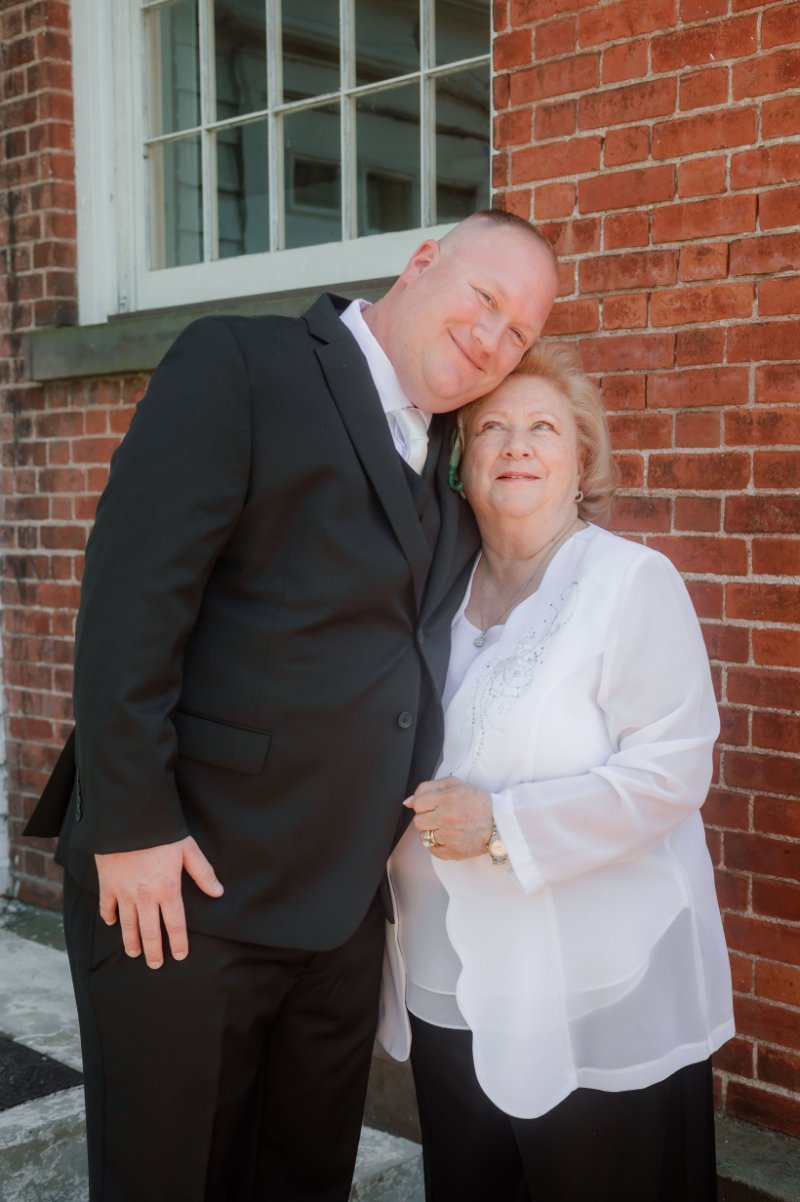  Wedding photography checklist moment of the groom sharing a sweet, loving embrace with a family member. 