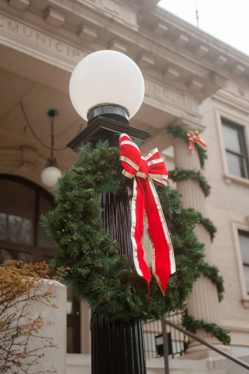  Christmas wreath with a red and white ribbon decorating a New York City building, adding festive charm to the holiday wedding season in NYC and New Jersey. 