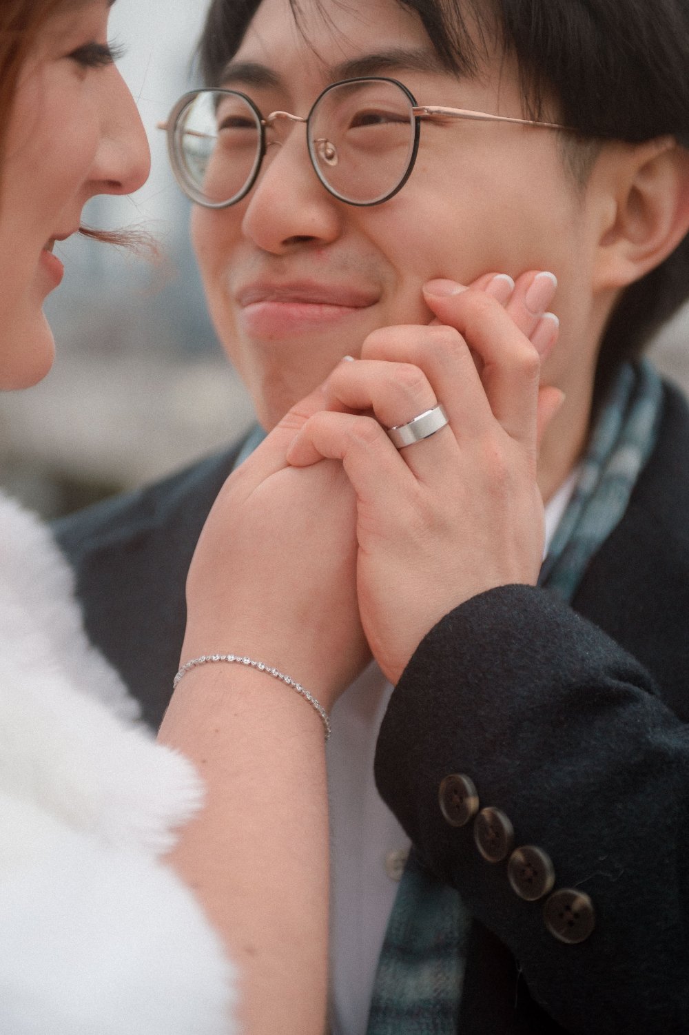  Close-up of newlyweds holding hands during their intimate NYC holiday wedding, showing a wedding ring and a sweet moment together, perfect for New Jersey and NYC wedding inspiration. 