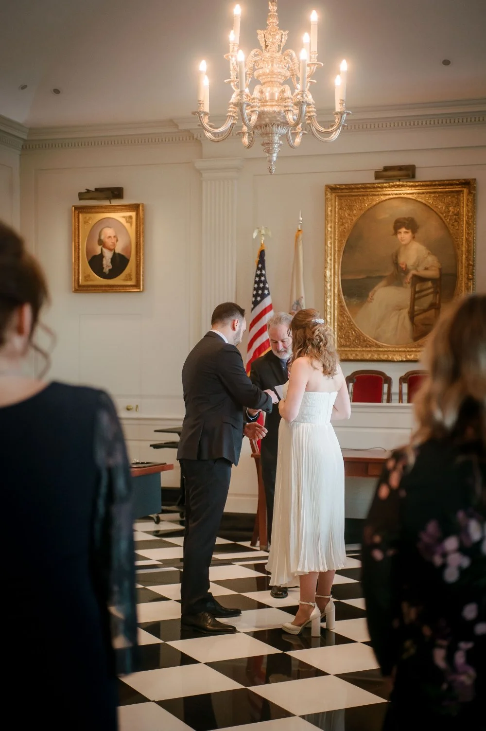  Newlyweds exchange rings during their intimate holiday wedding, winter wedding at the Hartley Dodge Memorial courthouse in Madison New Jersey inspired by New Jersey weddings. 