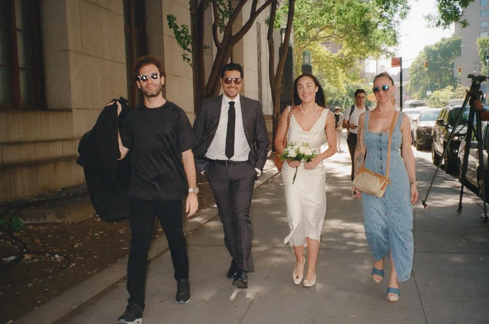  Newlyweds walking down a NYC street with friends after their intimate elopement ceremony. 