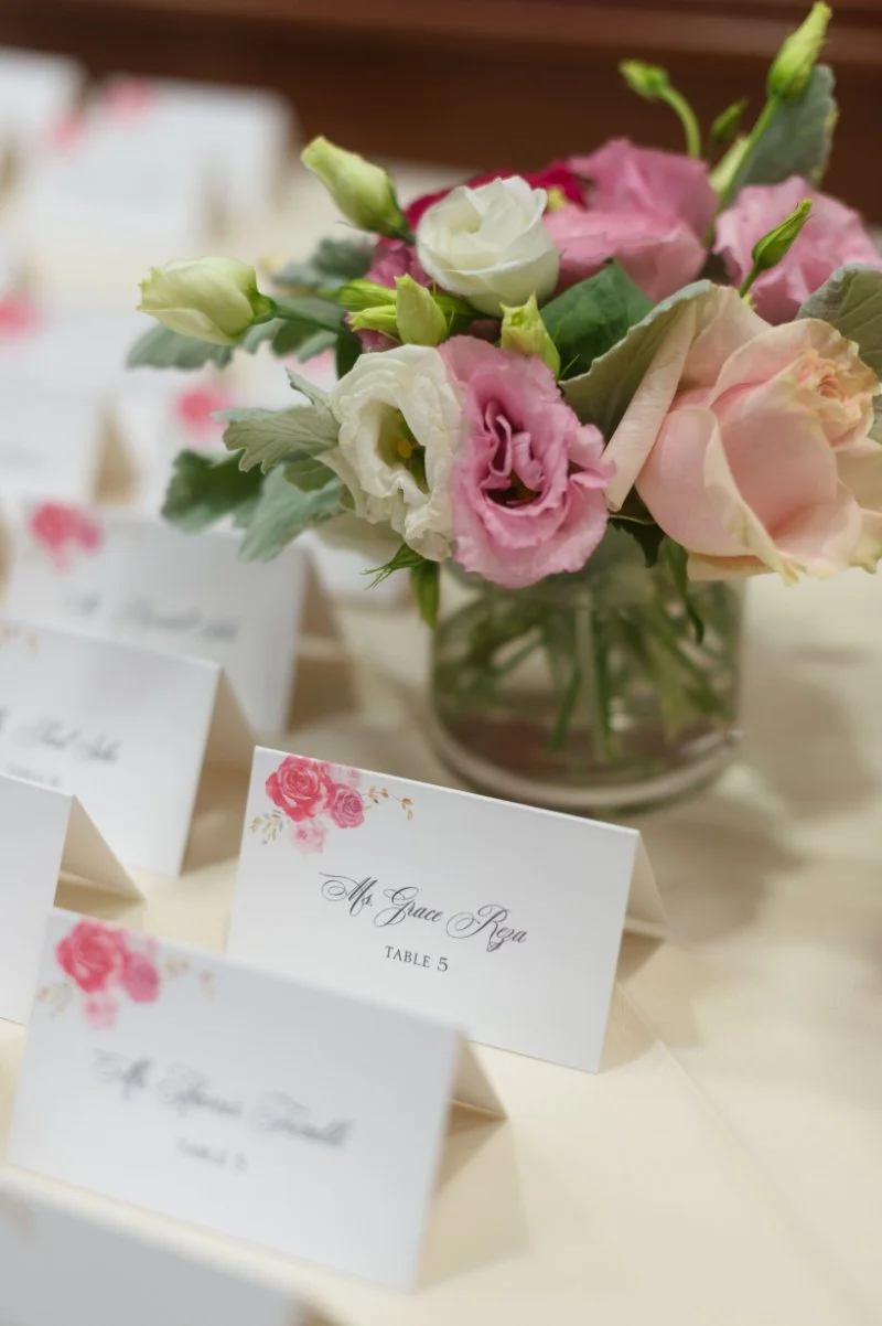Soft floral centerpiece with place cards, showing how to plan a small wedding with thoughtful table details
