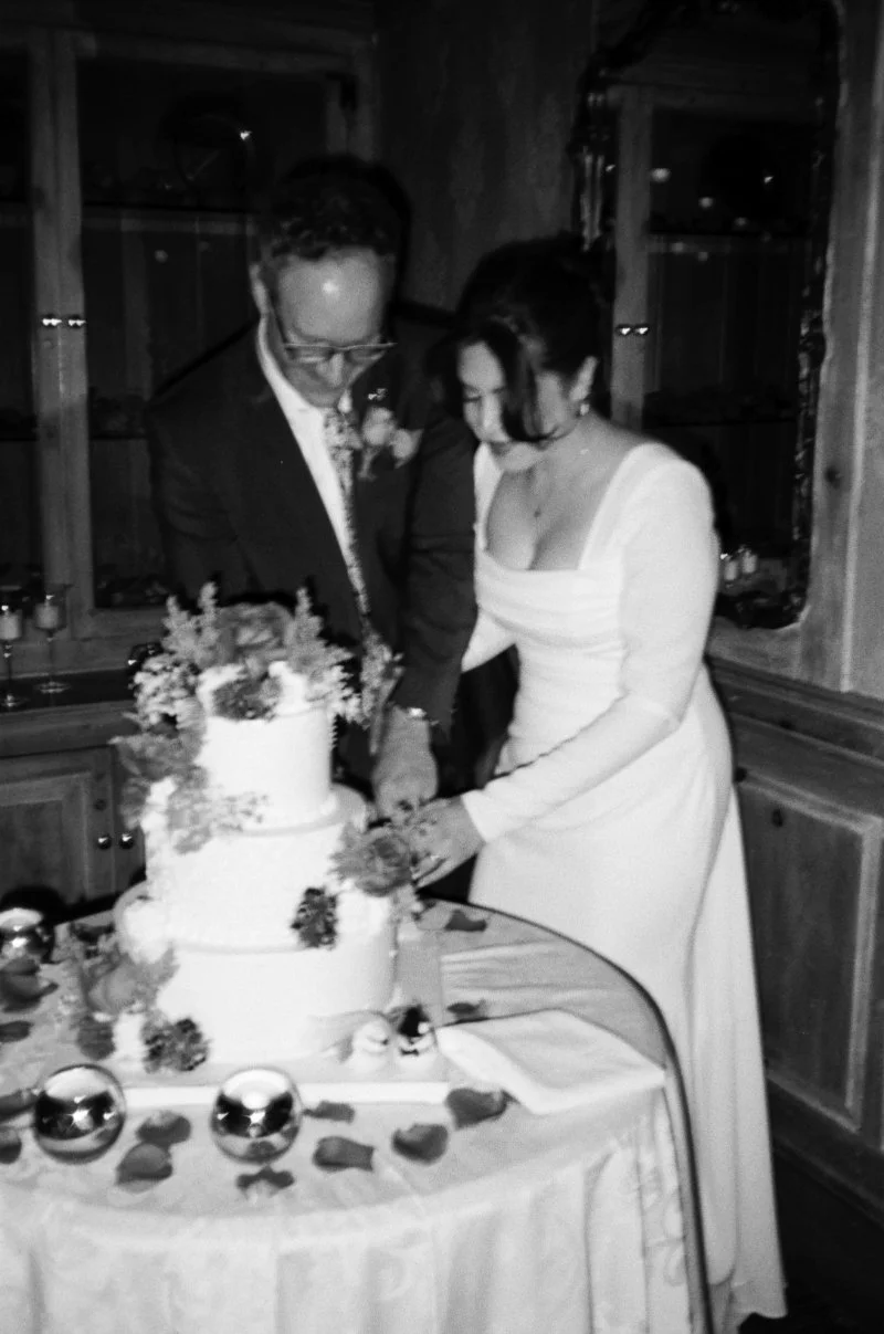 Bride and groom cutting cake at small wedding venues in NJ indoor reception.