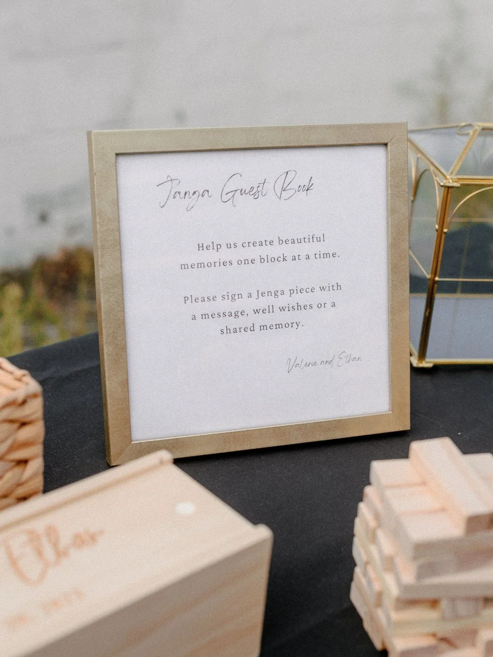 Wedding detail photos featuring a framed Jenga guest book sign displayed on the reception table.